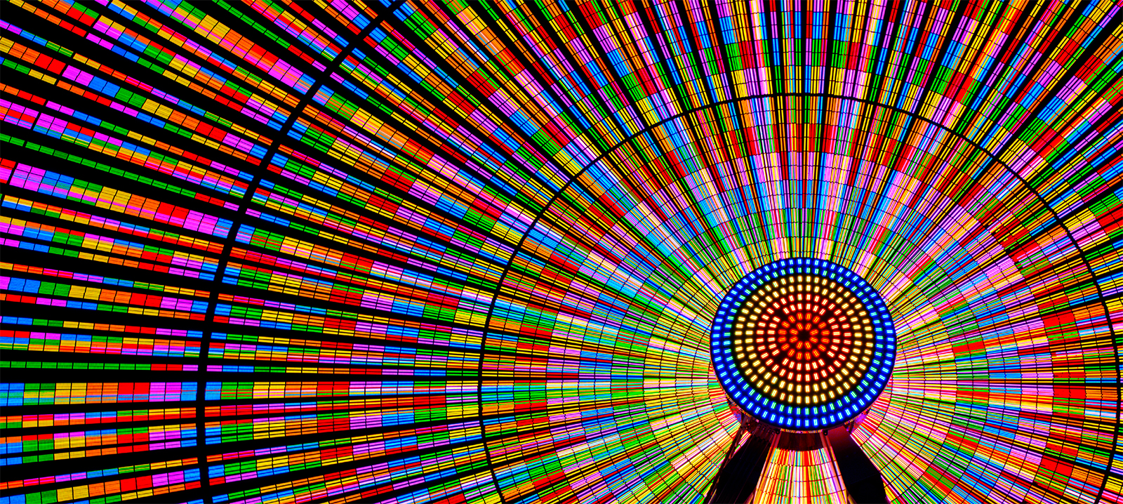 The Ferris wheel shines brightly with vibrant colors.