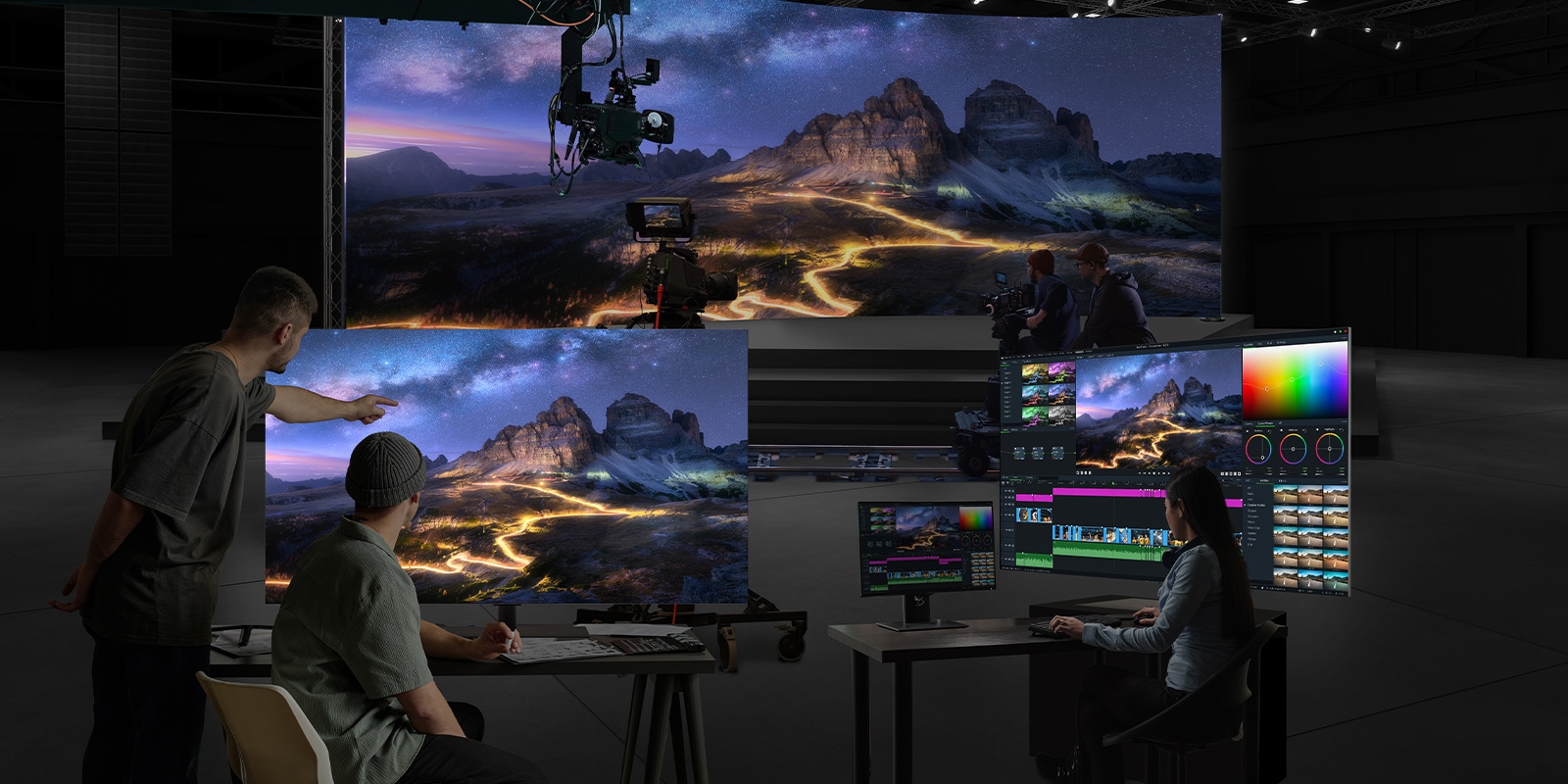 Filming is in progress in a studio with a large LED screen as the background. One 65EP5Q is used for color grading, while another is displaying the output for monitoring.