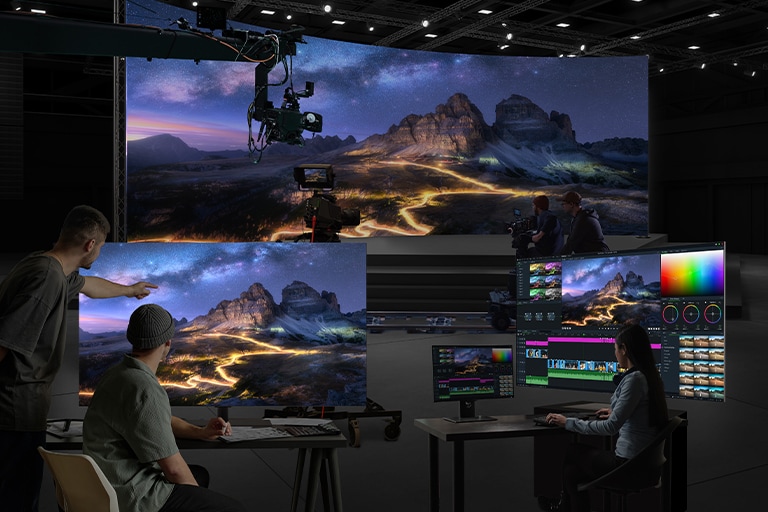 Filming is in progress in a studio with a large LED screen as the background. One 65EP5Q is used for color grading, while another is displaying the output for monitoring.
