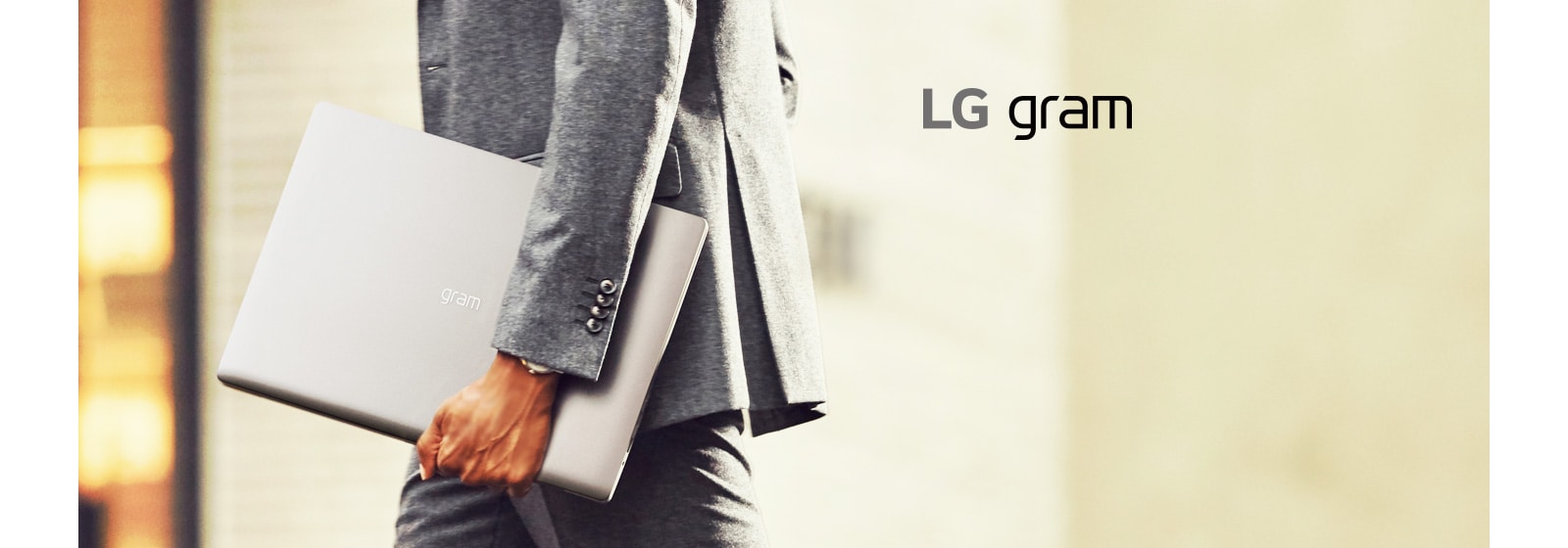 A business man is holding LG gram 17 easily with one hand.