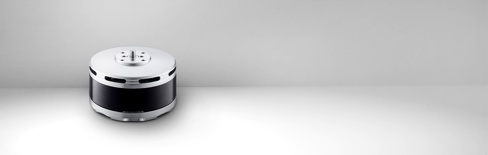 There is a Drone BLDC Motor in the background of gray gradation