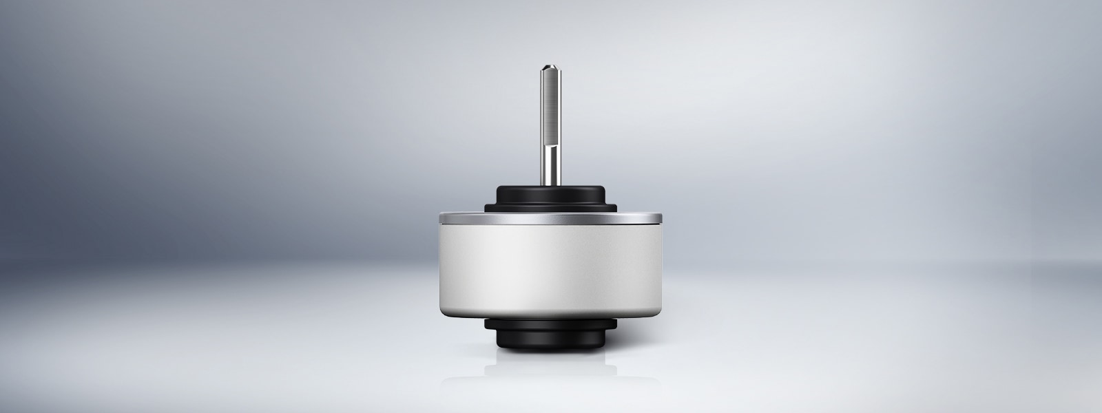 Front-facing view of an LG BLDC fan motor component on a reflective surface, showcasing the rotor shaft and cylindrical housing.