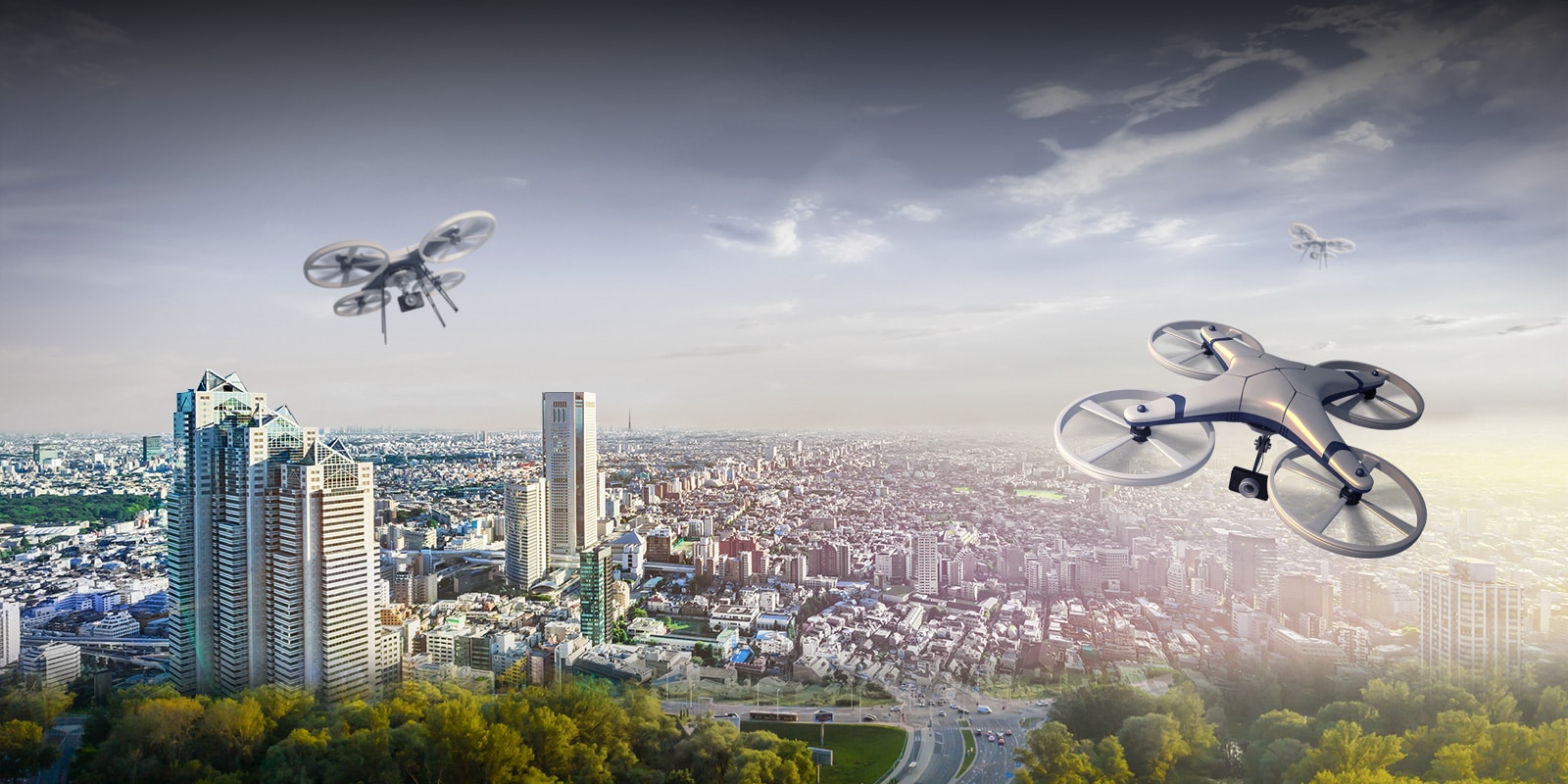 A drone is flying over the city sky.