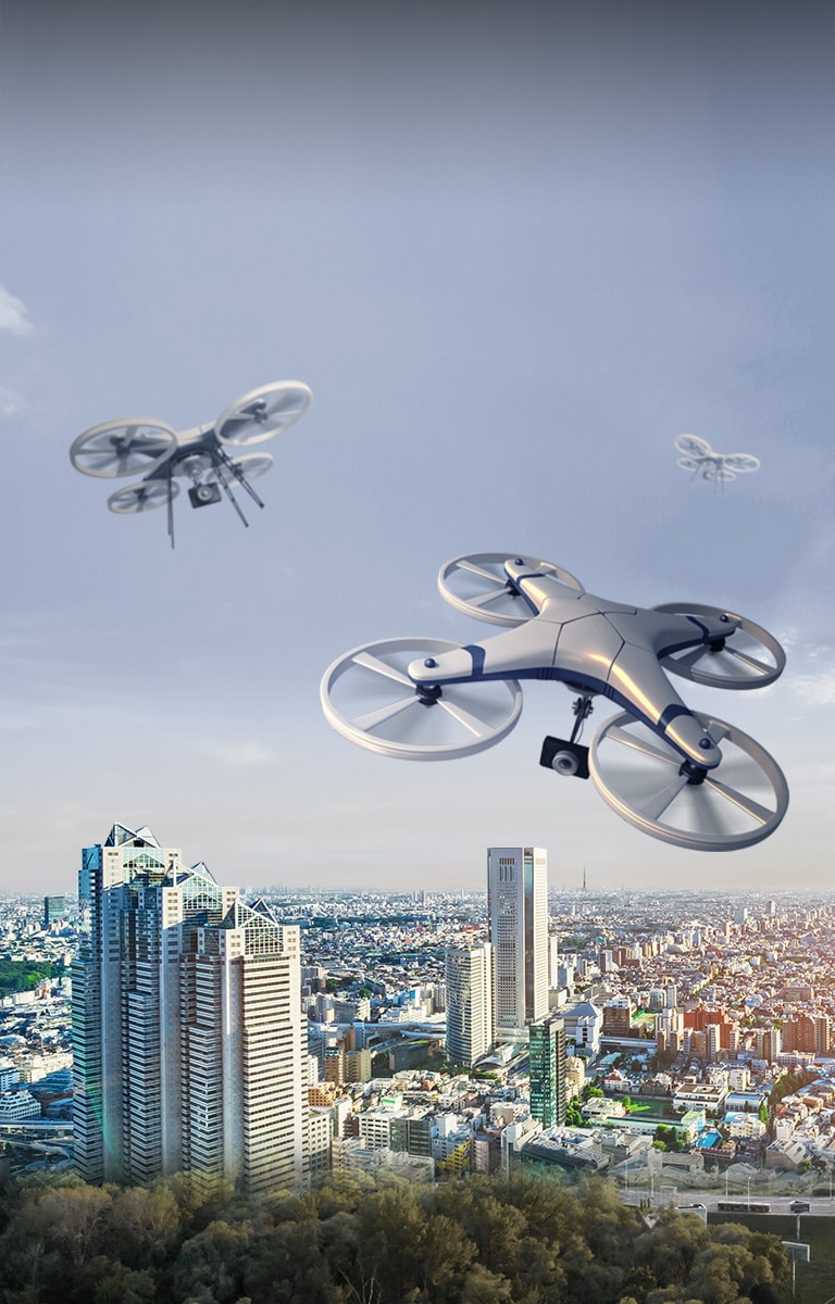 A drone is flying over the city sky.