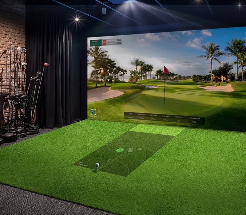 A golf simulator with moderate brightness; the projected screen appears dim and less vibrant, reducing visual clarity.	