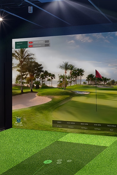A golf simulator with moderate brightness; the projected screen appears dim and less vibrant, reducing visual clarity.	