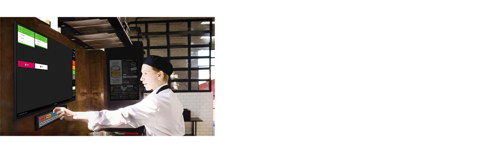 A kitchen staff member is checking order details on the kitchen display.