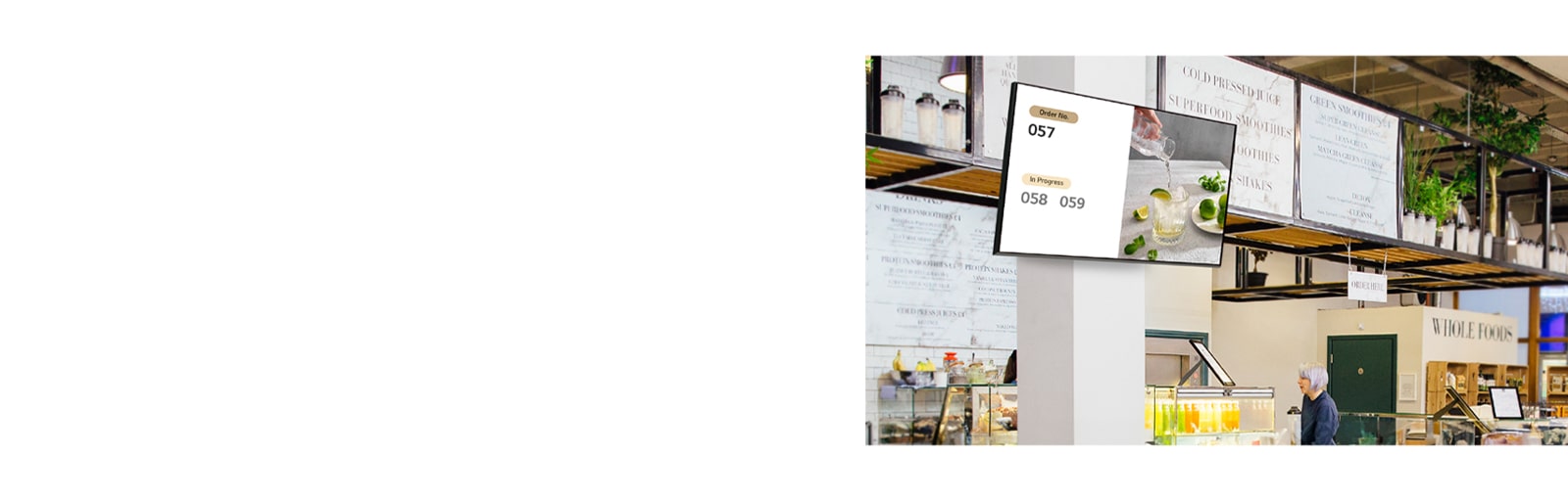 A signage screen mounted on a store wall displays menu images and related information.