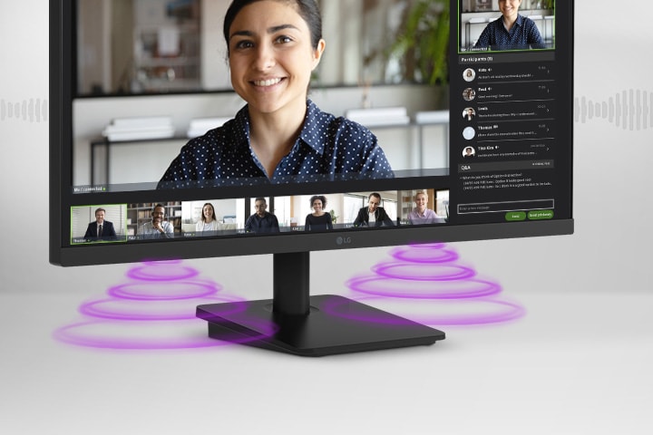 The monitor screen shows a video conference, while sound is coming from the speakers at the bottom of the monitor.	