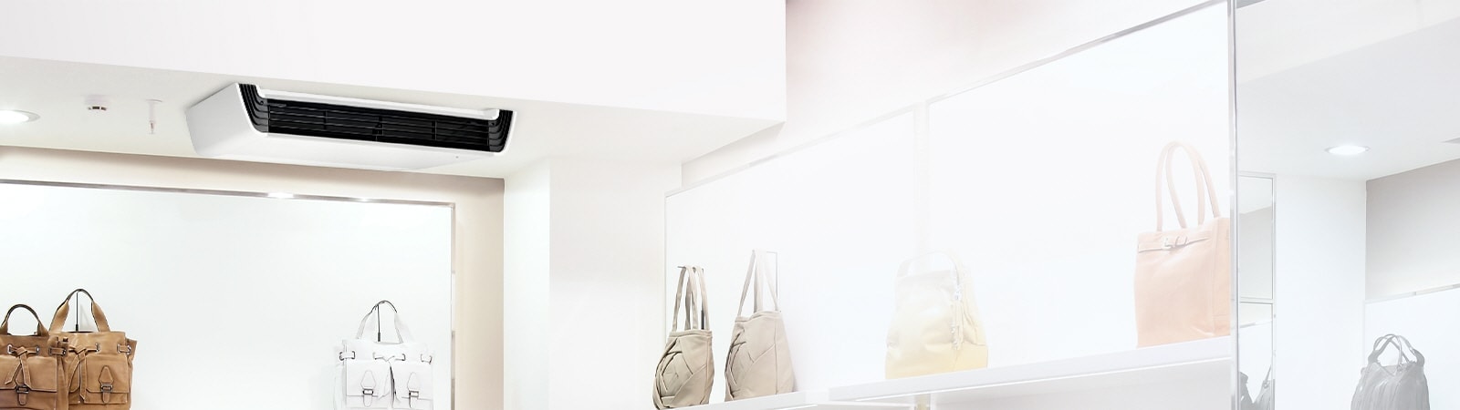 LG Ceiling Suspended unit, featuring a white body with a black front structure, is mounted on the ceiling adorned with a series of lights.