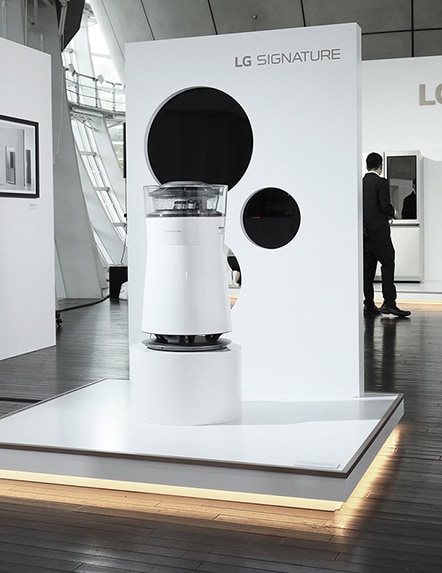 lg signature air purifier is displayed in front of the wall that has black circles on it at the launching event in tokyo japan