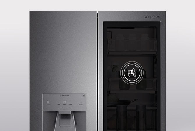 A silver refigerator with an ice maker on the left and a dark, opaque panel on the right with a symbol to knock
