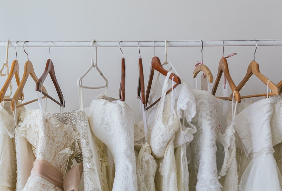 White dresses on hangers. Both style and color can work as intuitive classifiers of clothing.