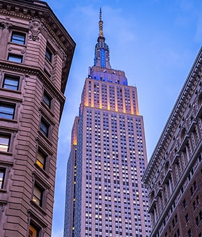 A photograph of the Empire State Building taken from street level.