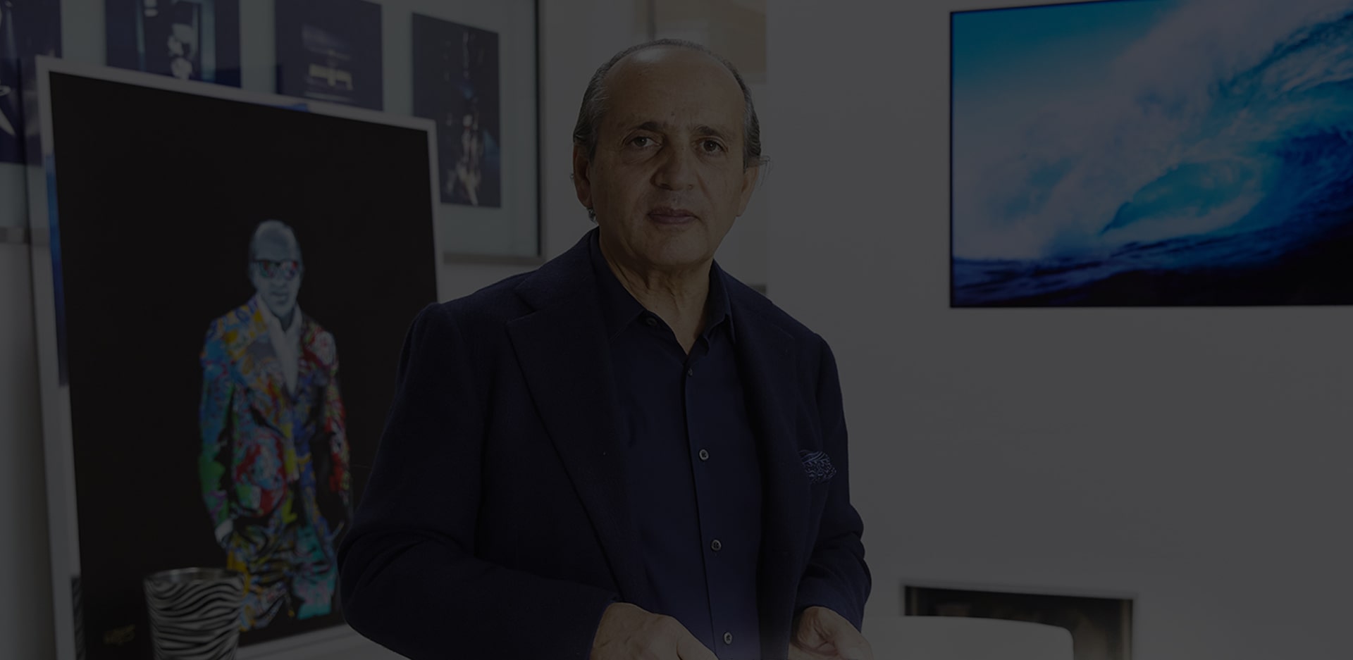 front view of hadi teherani staring forward with lg signature oled tv hung on the back wall