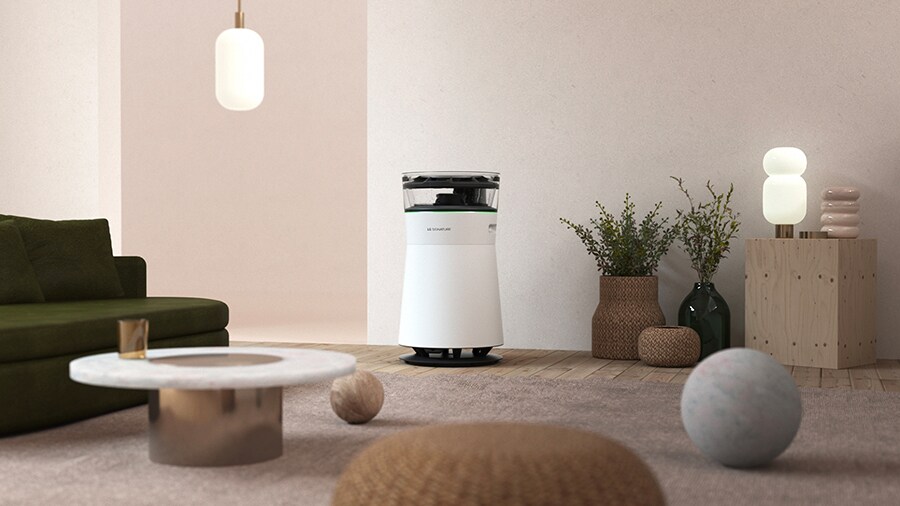 LG SIGNATURE Air Purifier is placed on the traquil living room with a color palette of nature, wood and greenery.