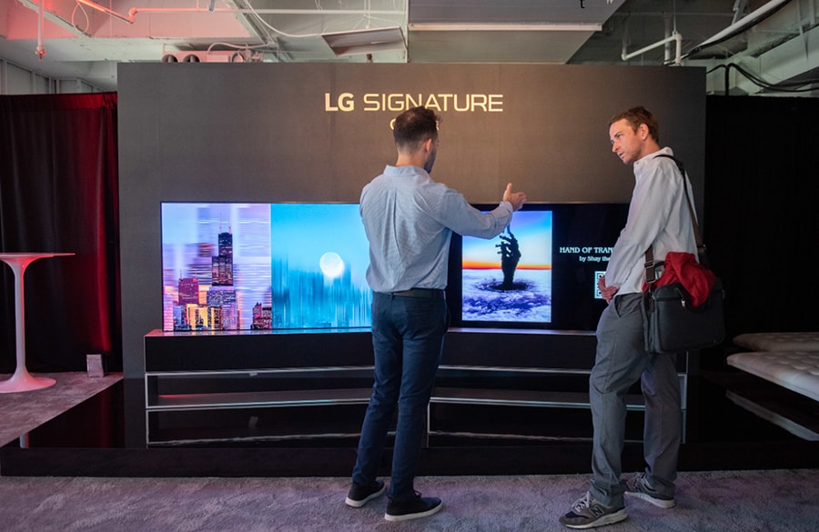 Event attendees view cutting-edge NFT artworks on the revolutionary LG SIGNATURE OLED R, the world's first and only rollable TV.