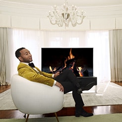 John Legend relaxing in front of a rollable TV