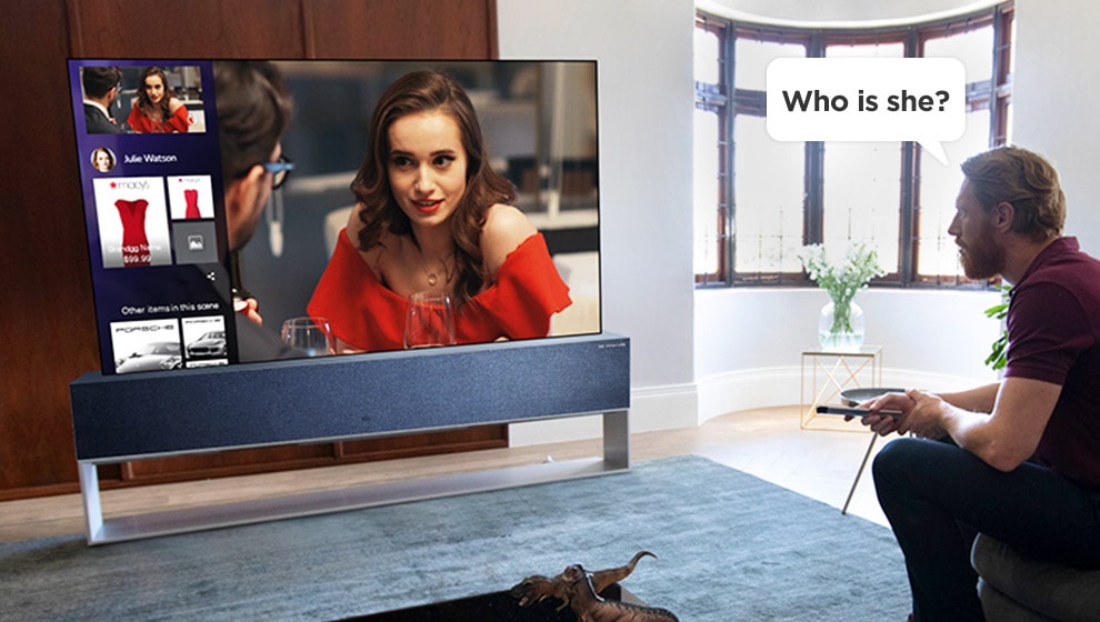 Man asking TV, "Who is she?" to find out who the actress is.