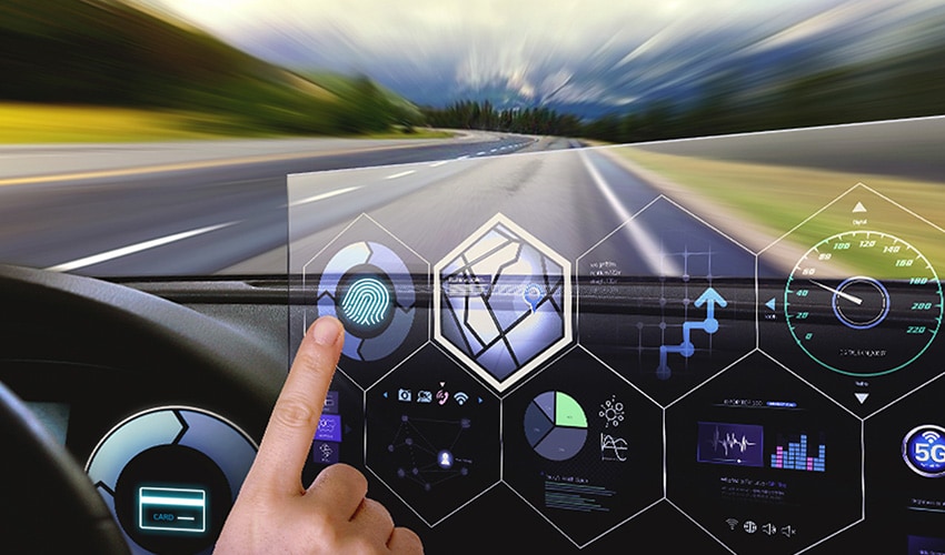 An image of a finger pointing the screen inside a car 