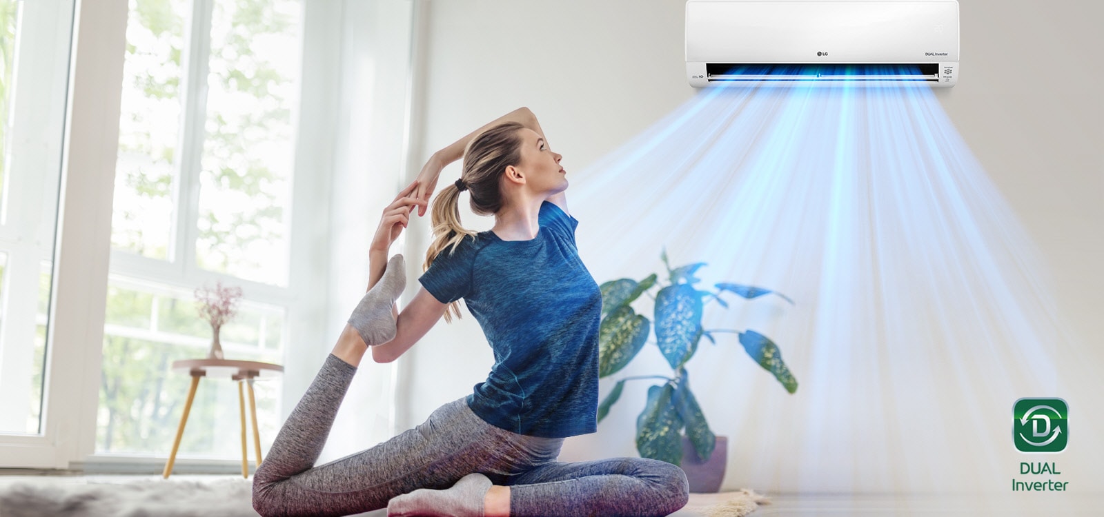 A woman stretching on the floor.  In the background is the air conditioner blowing out "blue" air, blowing it over the woman and into the space.  The Dual Inverter logo is in the lower right corner.