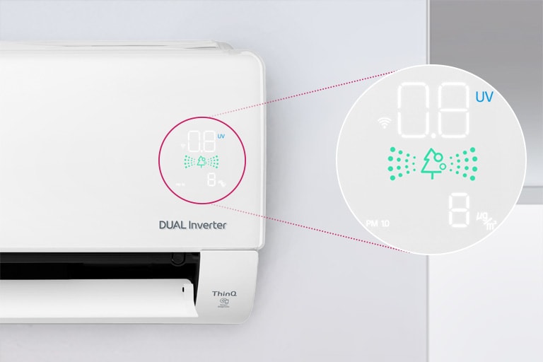 It shows half of the LG air conditioner mounted on the wall, with the front flap open, indicating that it is in operation.  The air quality readings on the machine are surrounded by a circle and this circle expands and magnifies to show the green air quality panel readings and numbers that indicate the exact air quality.  The DUAL Inverter logo can be seen on the machine.