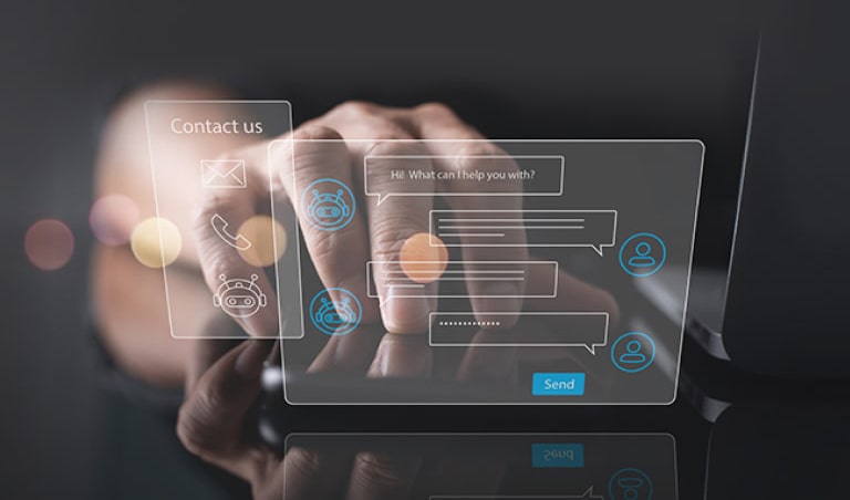 Two virtual hologram windows which are chatting and contact us float next to the laptop and hands are placed behind them.