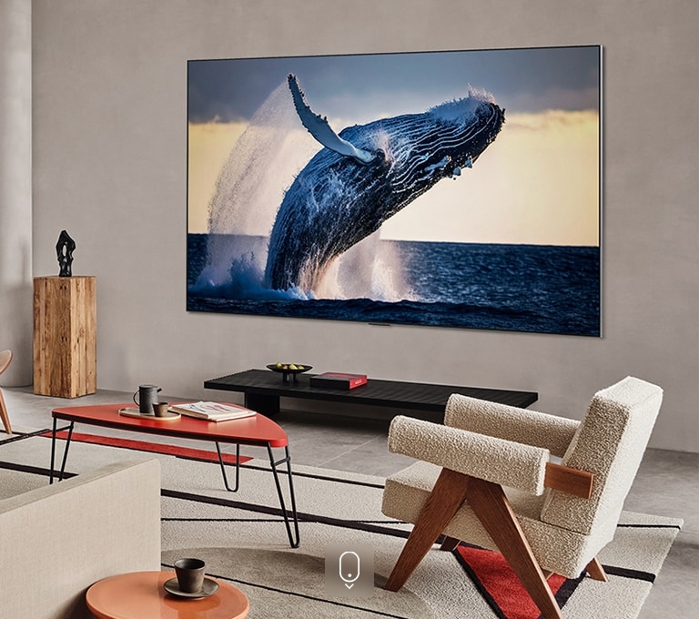 A TV in a stark room displays bright and vivid sunset on the screen.