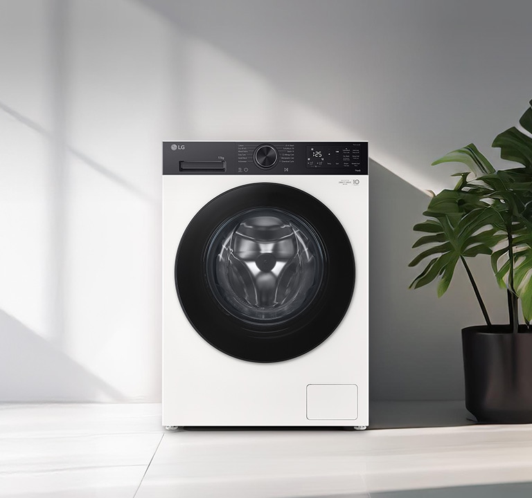 Πλυντήριο ρούχων εμπρόσθιας φόρτωσης τοποθετημένο σε ένα σύγχρονο πλυσταριό