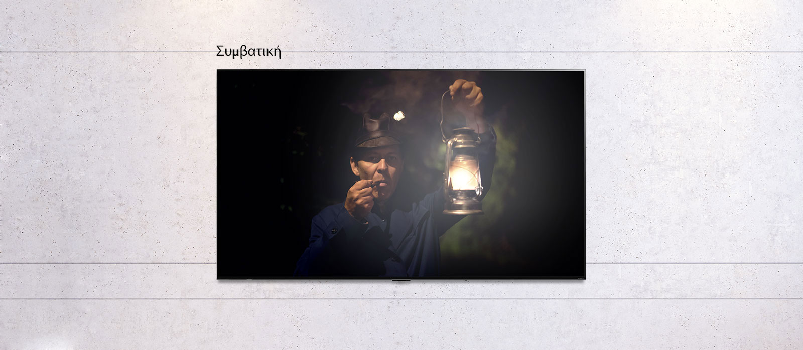 Κυλιόμενη εικόνα μιας επίτοιχης τηλεόρασης, στην οποία απεικονίζεται μια σκοτεινή σκηνή ενός άντρα που κρατά ένα φανάρι. Η σκηνή εναλλάσσεται ανάμεσα σε μια τηλεόραση κανονικού μεγέθους και μια τηλεόραση LG QNED MiniLED με μεγάλη οθόνη.