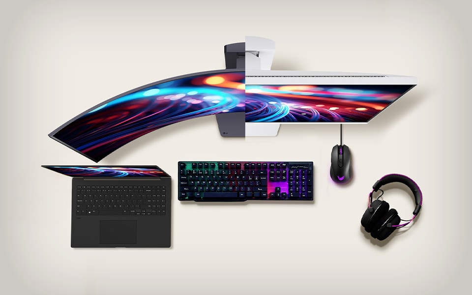 Top view of LG curved monitor, keyboard, mouse, laptop, and headset