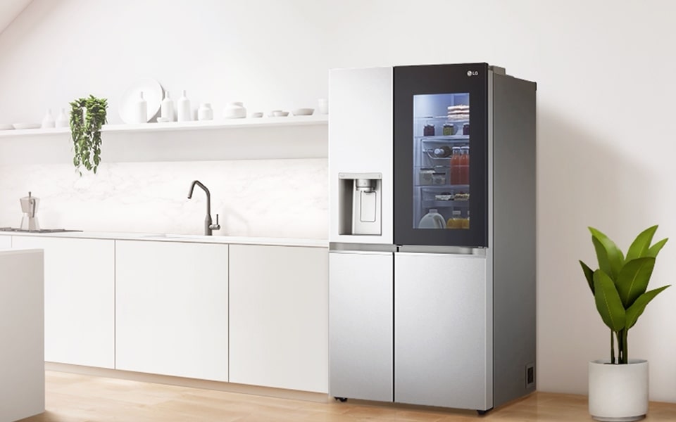 A stainless steel LG InstaView™ ThinQ™ smart refrigerator in a modern plant-filled kitchen 