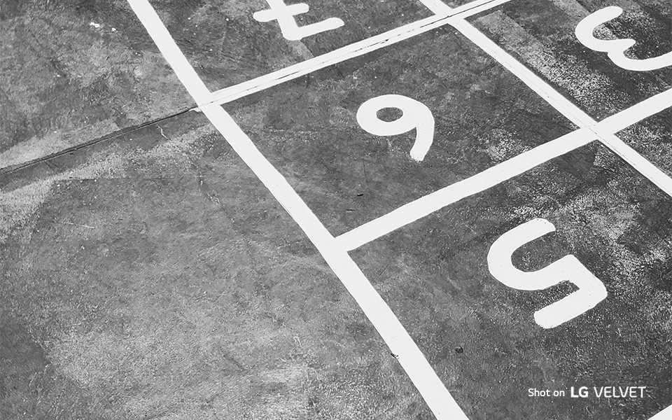 An image of floor with chalk drawing of numbers shot on LG VELVET