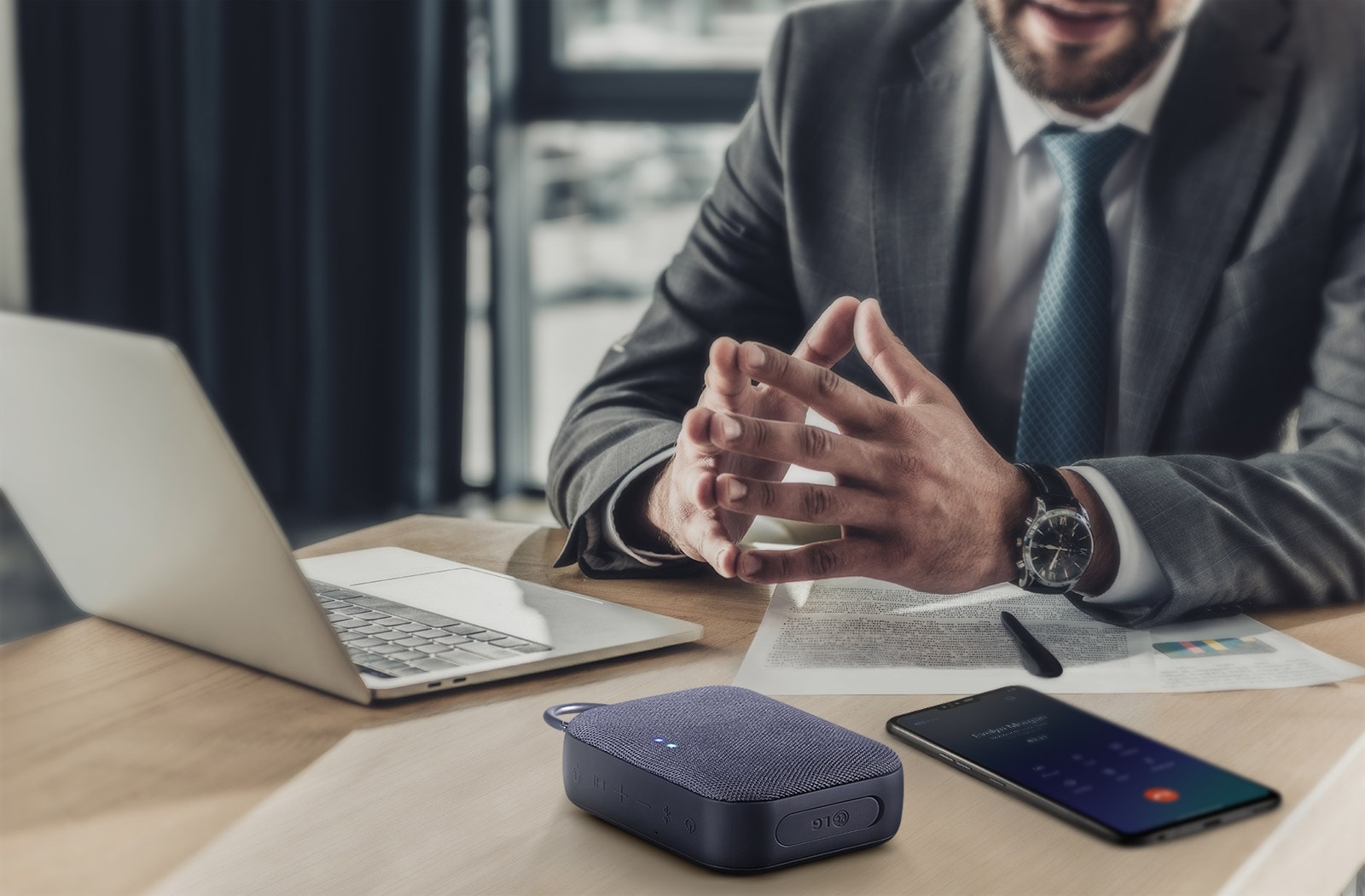 Two PN1 each placed on the left and right, slightly facing each other. There is a logo of two circles twisted within a big rainbow outlined circle ring placed between two PN1 products.