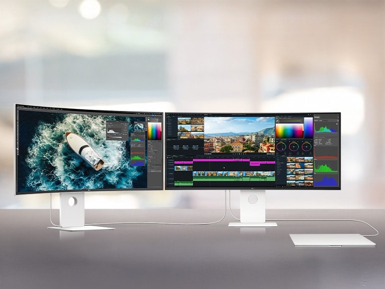 Two UltraFine monitors are placed side by side, connecting to one another with a laptop. The workstation shows how seemlessly the whole devices are connected.	