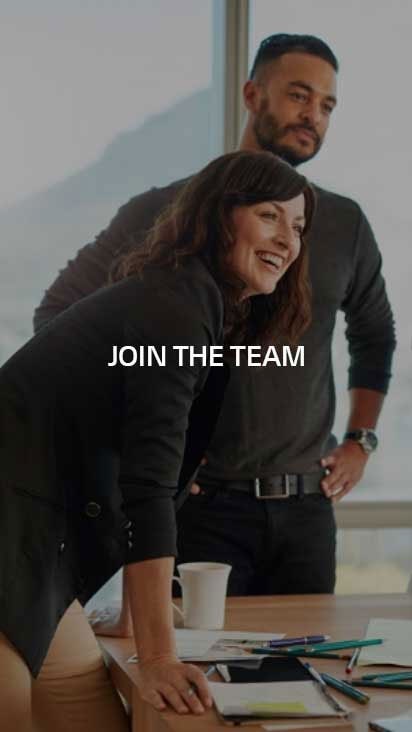 A man and a woman standing in a meeting room