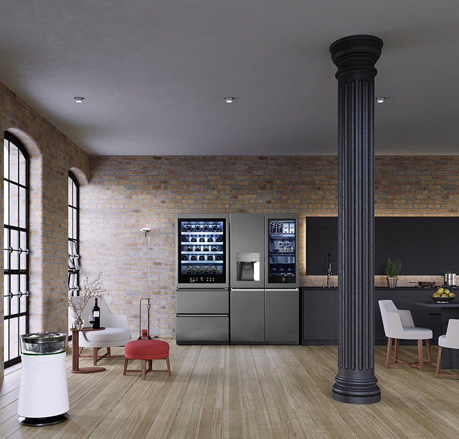 Il frigorifero e la cantina di LG SIGNATURE sono posizionati nella cucina del magazzino in mattoni con gli arredamenti di Flexform.