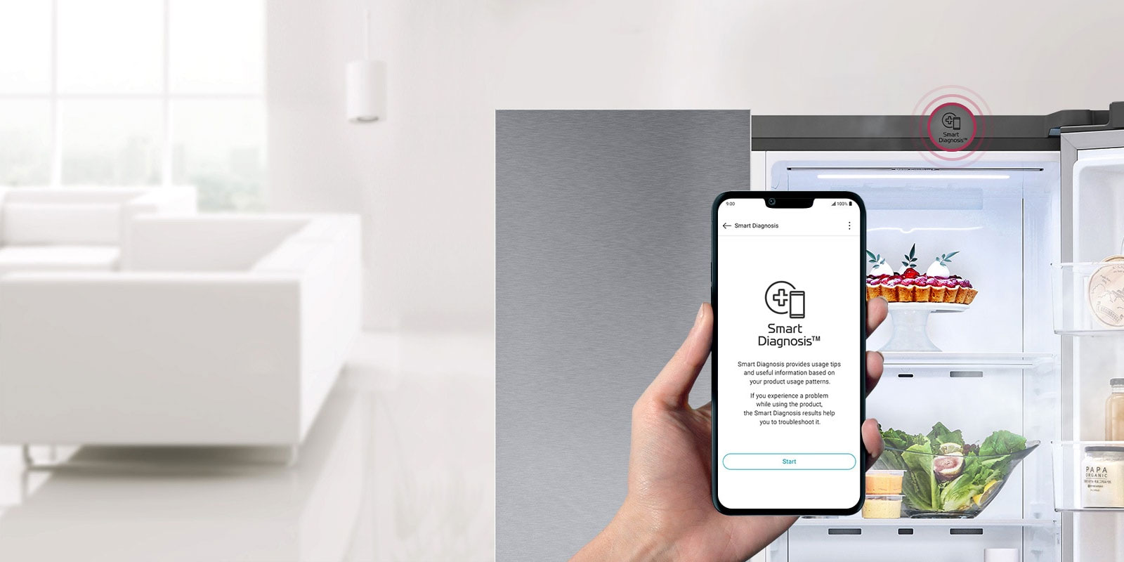 يد تمسك بهاتف. تعرض شاشة الهاتف تطبيق التشخيص الذكي. الثلاجة في الخلفية وأحد بابيها مفتوح لتظهر المحتويات بداخلها.