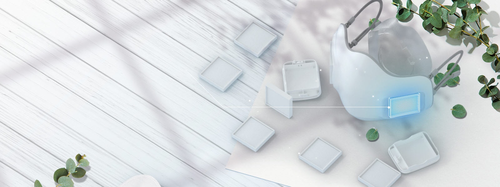 يتم عرض جهاز تنقية الهواء القابل للارتداء LG PuriCare بزاوية من الأعلى مع مرشحات HEPA من الفئة H13 منتشرة على الطاولة حوله.  يتم تمييز مكان إدخال المرشح على القناع بمربع أزرق.