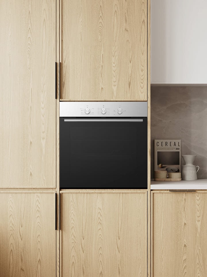 Modern kitchen with built-in black wall oven in light wood cabinetry.