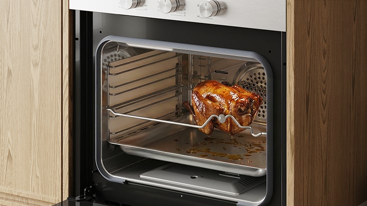 Hand adjusting touch controls on a built-in oven control panel.