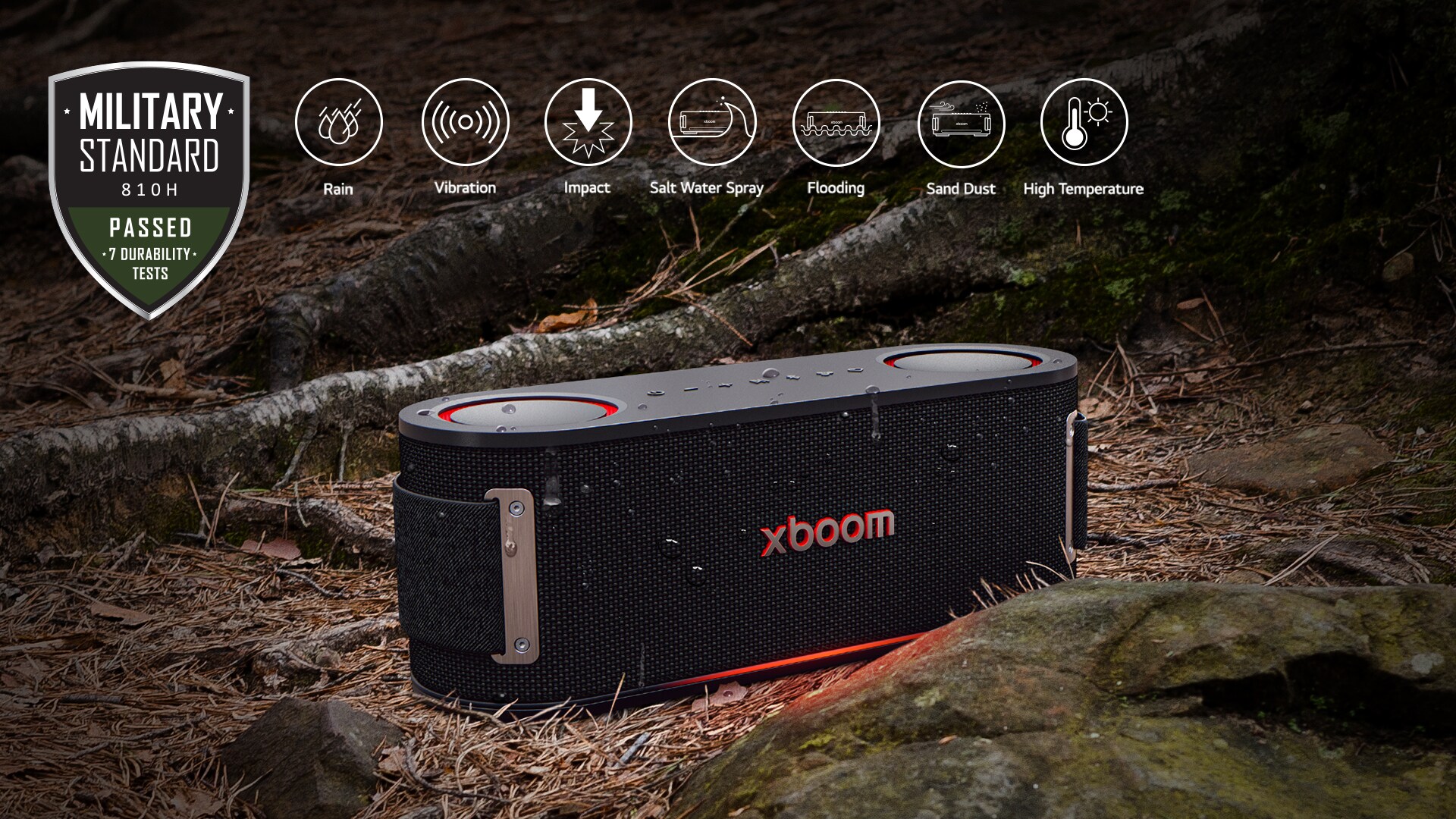 xboom Bounce is placed on soil covered with wet leaves, between a tree root and a stone. On the above left side Military standard logo is placed.