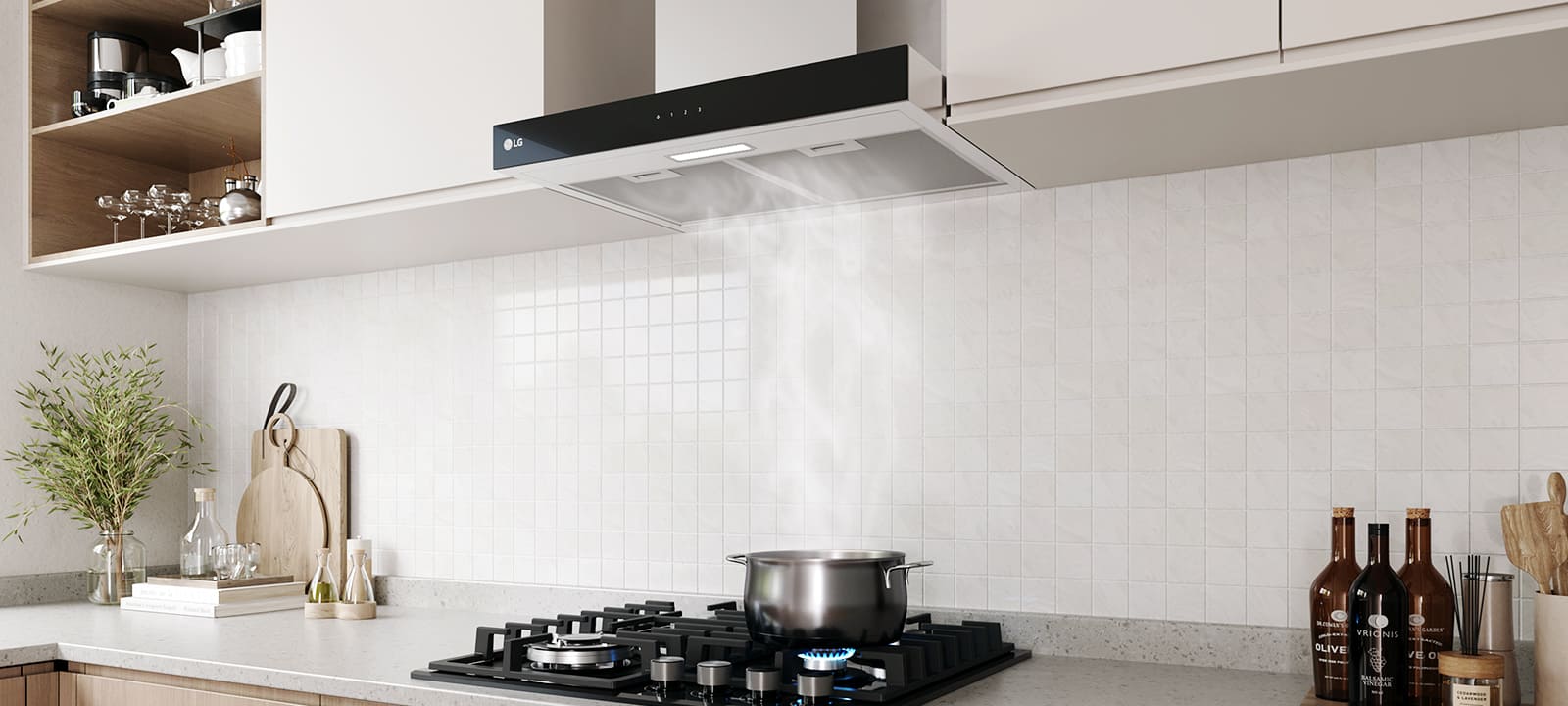 Modern kitchen interior featuring a built-in range hood above a gas cooktop with a pot, against a white tile wall.