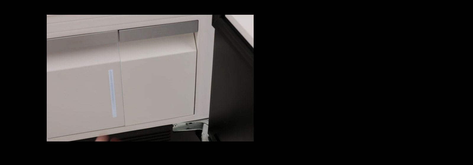 A person using built-in handy steamer in LG Styler to remove wrinkles from shirt with adjustable pressure settings