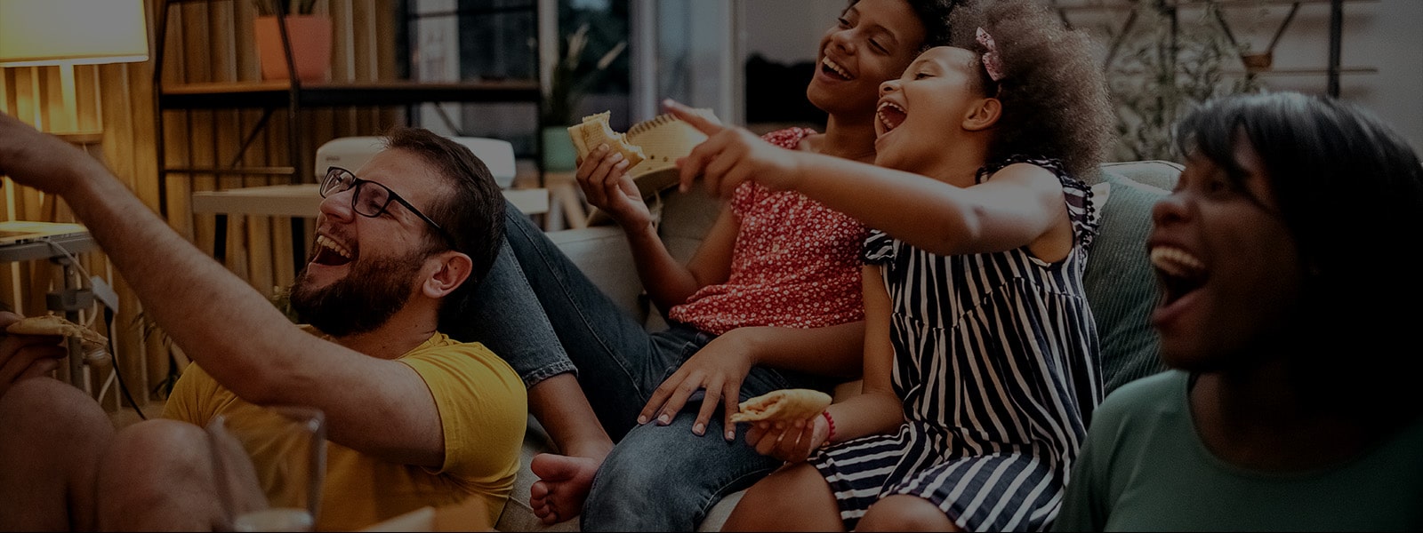 A group of friends gather in a huddle laughing.