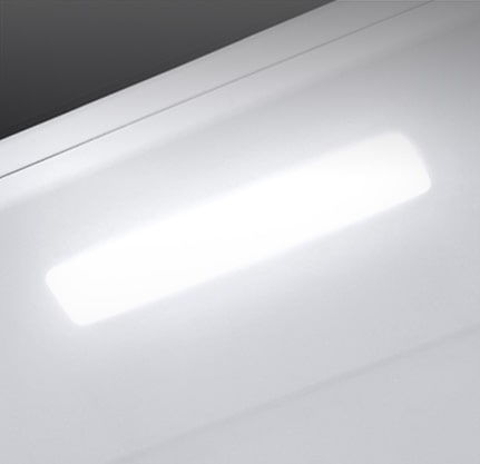 The top interior of the fridge is shown with the soft LED light bright.