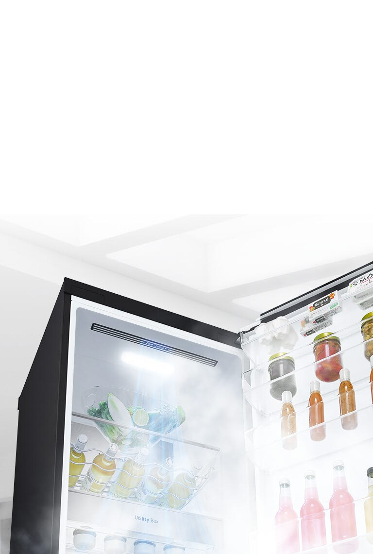 The refrigerator is shown open at an angle and filled with produce. White air is blowing from the top of the interior down around all of the food to keep it cool.