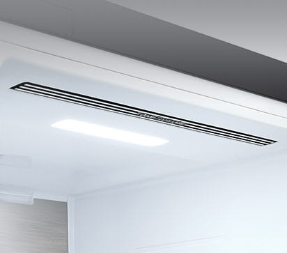The top interior of the fridge is shown with the soft LED light bright.