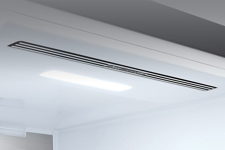 The top interior of the fridge is shown with the soft LED light bright.