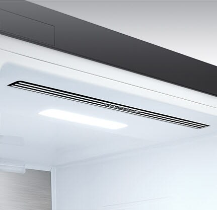 The top interior of the fridge is shown with the soft LED light bright.